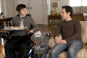 Trevor and Ben sitting in the living room in the movie The Fundamentals of Caring.