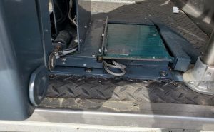 Defective VMI Ricon Slide-Away Wheelchair Lift with wires sticking out in need of repair.